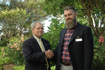 Mr. Cooper & Mr. Hudson shaking hands. 