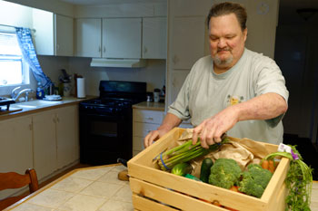 Brian Christman in his kitchen with food box