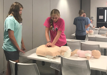 Students practice newly mastered CPR skills 