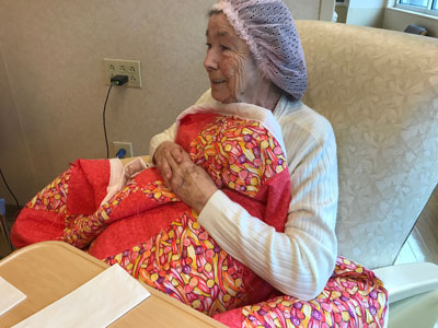Shirley Franks, a patient at Tunnell Cancer Center, accepts her new quilt.
