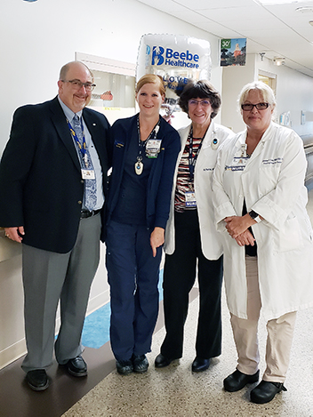 Dareth Penuel, RN (second from left) is the recipient of Beebe Healthcare’s August 2019 L.O.V.E. Letter. Also pictured from left to right are Rick Schaffner, Interim CEO, Executive Vice President and Chief Operating Officer; Margaret Porter, RN, Nurse Man