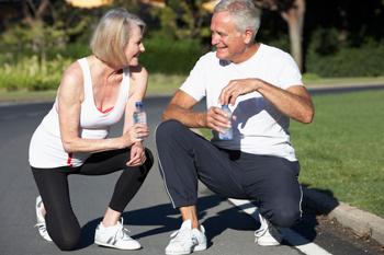 Couple rests to drink water while exercising.