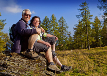 Mature couple hiking in state park.