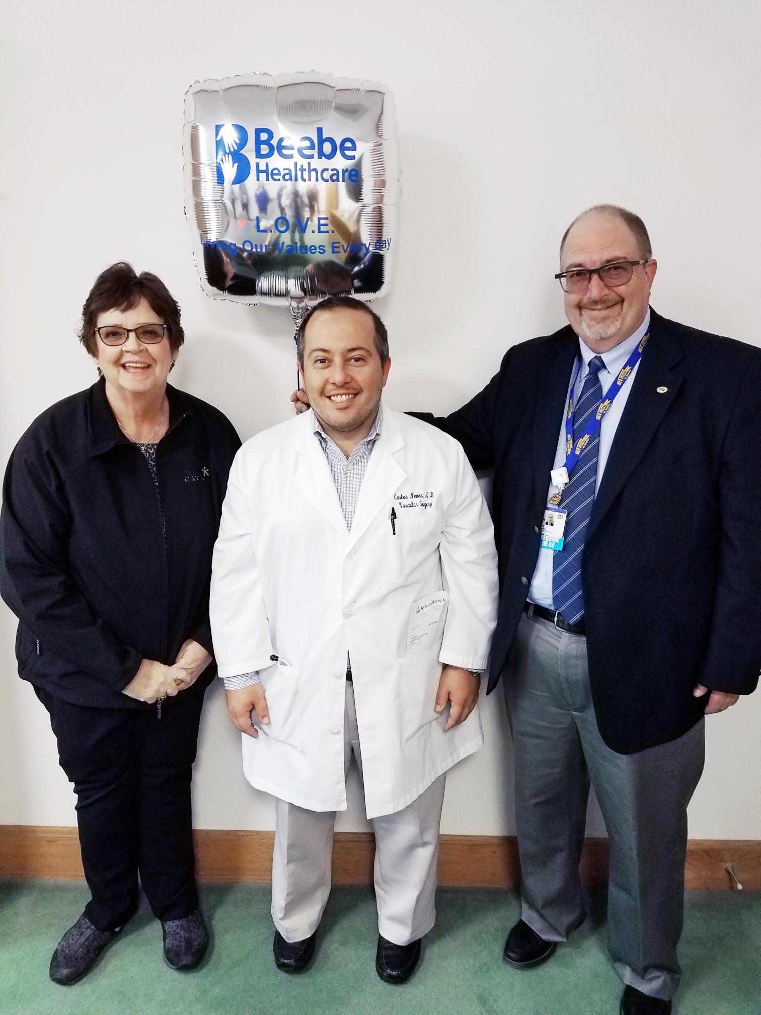 Carlos Neves, MD, Vascular Surgeon at Beebe Healthcare, is the recipient of Beebe’s November 2019 L.O.V.E. Letter. Also pictured are Catherine Walls, Patient Experience Coordinator, and Rick Schaffner, Interim CEO, Executive Vice President, Chief Operatin