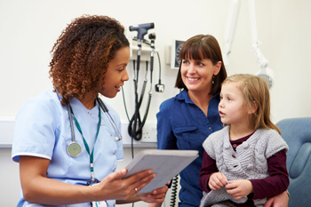 Nurse practitioner talks to patient.