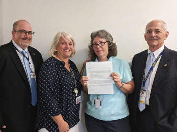 Liz Dean, Discharge Planner, (second from right) is the August 2018 recipient of the L.O.V.E. Letter Award. Also pictured from left to right are Rick Schaffner, Executive Vice President and Chief Operating Officer; Ann Regacho, Discharge Planner; and Jeff
