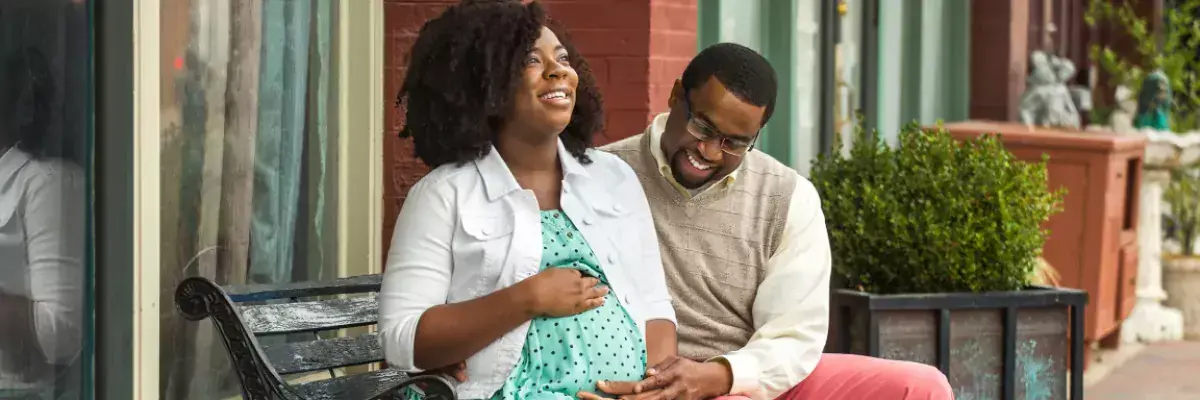 Pregnant woman and husband enjoying sunshine