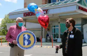 Ed Gilpin celebrates the excellent care his wife, Lois, received at Beebe along with his friend Catherine Walls, Beebe Healthcare’s Patient Experience Program coordinator.