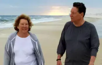 Sharon Keegan-Coppels and Preston Coppels enjoy one of their many walks on the beach. This photo was taken prior to the COVID-19 pandemic and prior to cloth mask regulations.