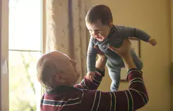 Grandfather enjoying time with baby after surgery
