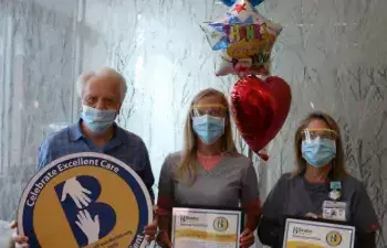 Bill Dailey celebrates the excellent care he received at Beebe with Crystal Godzieba, center, and Sherry Ricci.