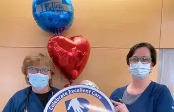 Tara Cooper, right, celebrates the excellent care that Denean Cox has provided to Beebe Healthcare patients during her more than 30 years of service.