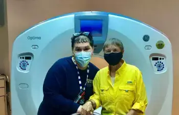 Mary Jo Cauley, left, is shown with grateful patient Kim King in front of the CT scan at Beebe