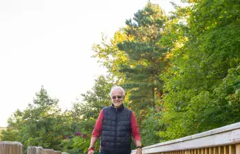 Rich Hoffheins and his dog walk on the boardwalk