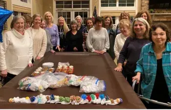 Senators group knitting baby caps