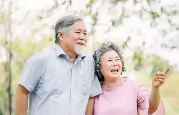 A happy older couple goes for a walk