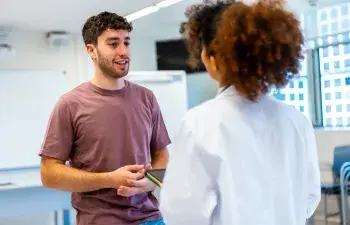 Young man talking with doctor