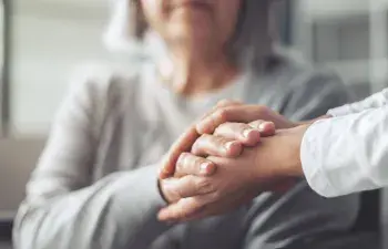 Hands holding old woman's hands