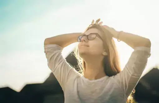 Woman in the sunshine with eyes closed
