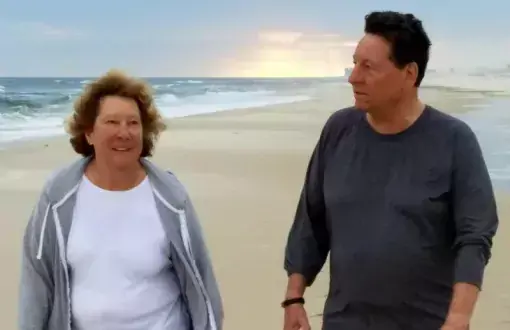 Sharon Keegan-Coppels and Preston Coppels enjoy one of their many walks on the beach. This photo was taken prior to the COVID-19 pandemic and prior to cloth mask regulations.