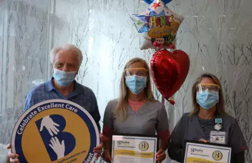 Bill Dailey celebrates the excellent care he received at Beebe with Crystal Godzieba, center, and Sherry Ricci.