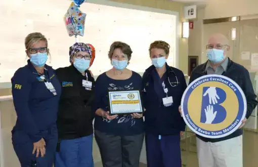 Bob Harmon, right, celebrates the care he received at Beebe with nurses (l-r) Jennifer Maxwell and Colleen Dudlek, his wife Kathy Harmon and PA-C Tricia Ecker.