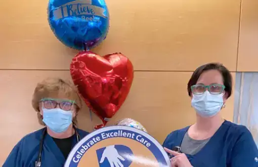Tara Cooper, right, celebrates the excellent care that Denean Cox has provided to Beebe Healthcare patients during her more than 30 years of service.