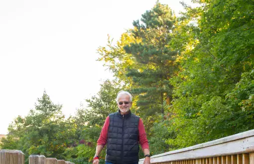 Rich Hoffheins and his dog walk on the boardwalk