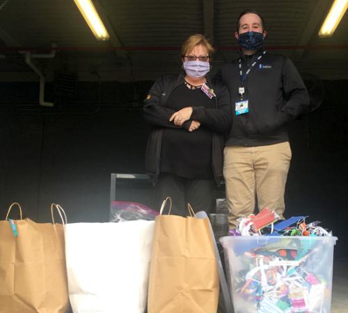 Cheryl and Andrew with masks sewn by community members for Beebe team members.