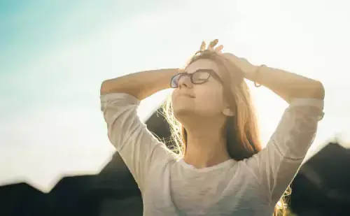Woman in the sunshine with eyes closed