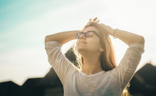 Woman in the sunshine with eyes closed