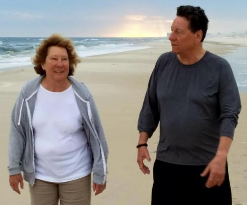 Sharon Keegan-Coppels and Preston Coppels enjoy one of their many walks on the beach. This photo was taken prior to the COVID-19 pandemic and prior to cloth mask regulations.