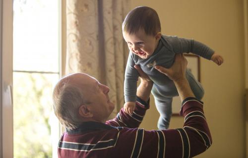 Grandfather enjoying time with baby after surgery