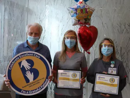 Bill Dailey celebrates the excellent care he received at Beebe with Crystal Godzieba, center, and Sherry Ricci.