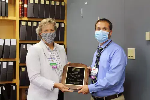 Kay Young of Beebe Medical Foundation presenting the Philanthropy Award to Dr. Bill Chasanov.