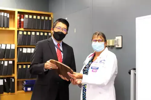 Dr. David Tam, President and CEO of Beebe Healthcare, presenting the Standards of Excellence Award for APPs to Lisa Shotyk, NP.