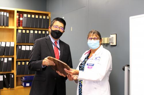 Dr. David Tam, President and CEO of Beebe Healthcare, presenting the Standards of Excellence Award for APPs to Lisa Shotyk, NP.