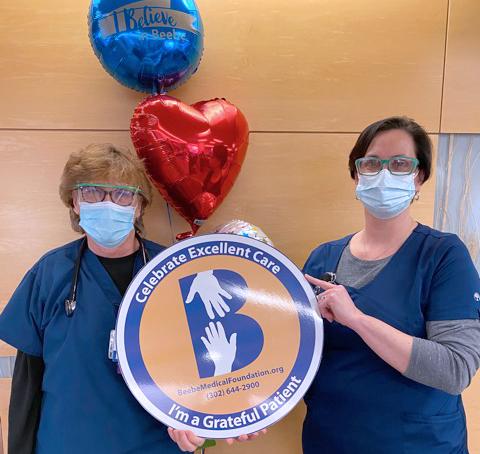 Tara Cooper, right, celebrates the excellent care that Denean Cox has provided to Beebe Healthcare patients during her more than 30 years of service.