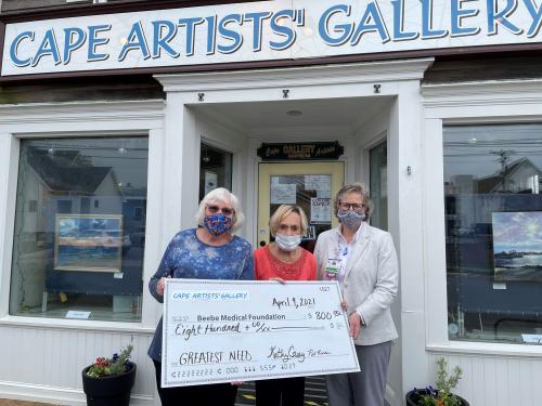Cape Artist Gallery Chair Kathy Casey and Cape Artist Group President Pat Riordan present their gift to Beebe Medical Foundation Executive Director of Development, Kay Young.