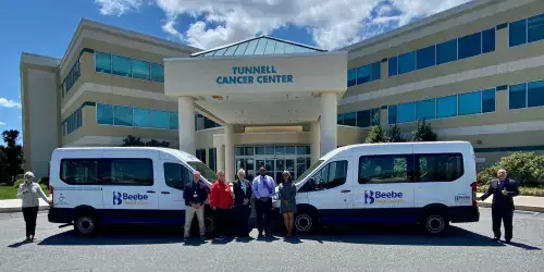 Van pic .jpg Beebe Medical Foundation Gift Officer Diane Barlow and President Tom Protack recognize vans provided by funds from the Jean & Joan Tournament and Beebe Medical Foundation.