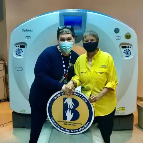 Mary Jo Cauley, left, is shown with grateful patient Kim King in front of the CT scan at Beebe