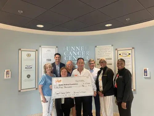 Photo, from left to right: Kas Naylor, Sean Flanigan, Sheila Bravo, Bing Crosby, Denny Santangini, Larry DeFrancisco, Rita Williams, and Alexia Hines during the check presentation.