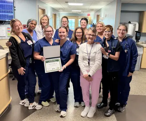 Shaelee O’Reilly, RN (front row, holding certificate), celebrates receiving the DAISY Award for Nursing Excellence with her Beebe Healthcare colleagues.