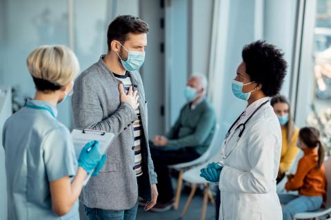 Doctor speaks to patient in waiting room