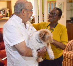 Content image: Cynthia with partner, Eric, and their dog. Image file: Cynthia with partner, Eric, and their dog.
