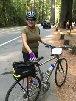 Content image: Sue cycles through the Redwoods, California. Image file: Sue cycles through the Redwoods, California.