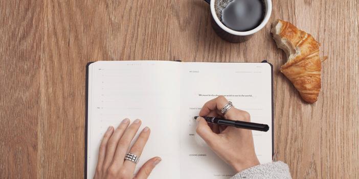 woman writing in her food journal