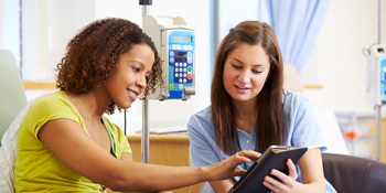 Woman talks to nurse about surgery options. Beebe offers advanced cancer treatment with HIPEC.