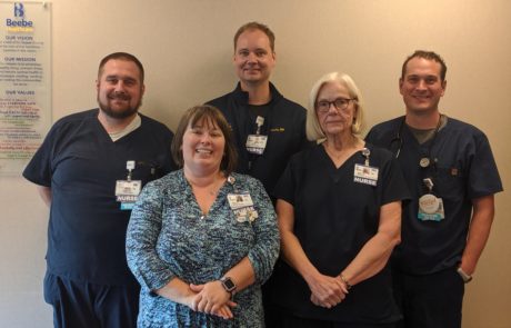 Pictured here are members of the Vascular Access Team, which has been instrumental in reducing central line associated bloodstream infections, or CLABSIs. In 2018, Beebe went 466 days – well over a year! – without a single CLABSI. Front row (L to R): Shelly Robinson BSN, RN, VA-BC; Mary Jo Warwick, RN. Back row: CJ Marshall, RN; Gavin Zakarevicz, RN; Mike Kent, RN.